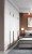 Długi czarno-złoty liniowy uchwyt meblowy Tulima w pionowym montażu na białych drzwiach szafy