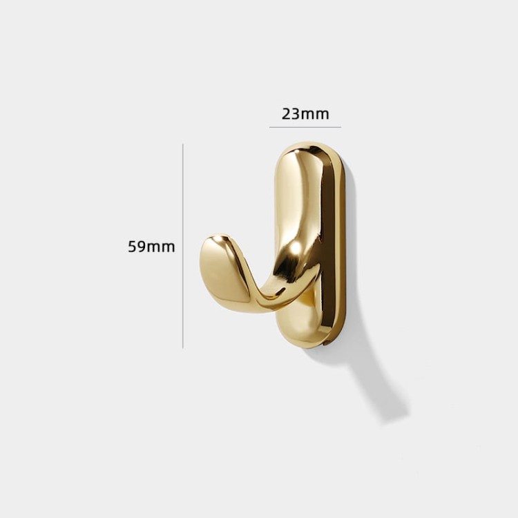 Wandhaken Bello – eleganter Haken mit geschwungener Form aus robustem Metall. Ideal für Flur, Bad und Garderobe. Farben: glänzendes Gold und Perlgrau. Montageschrauben im Set.